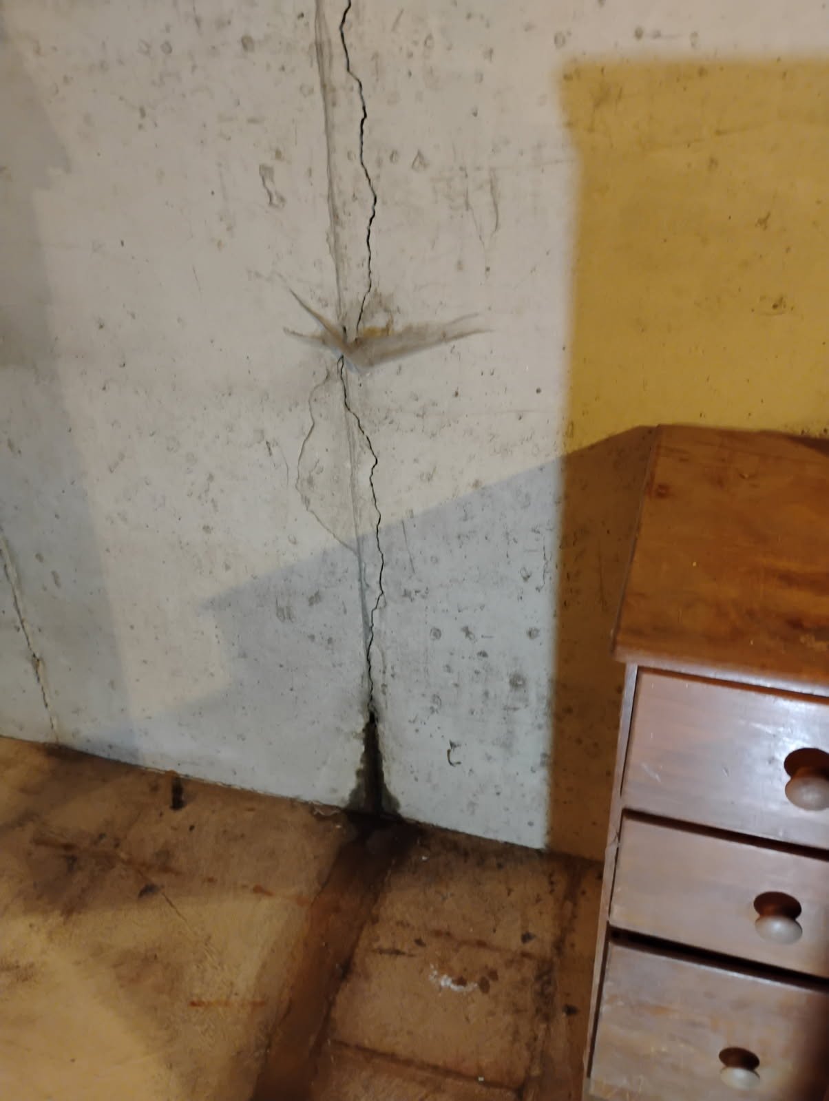 Close-up of active water leak through foundation crack in Framingham basement