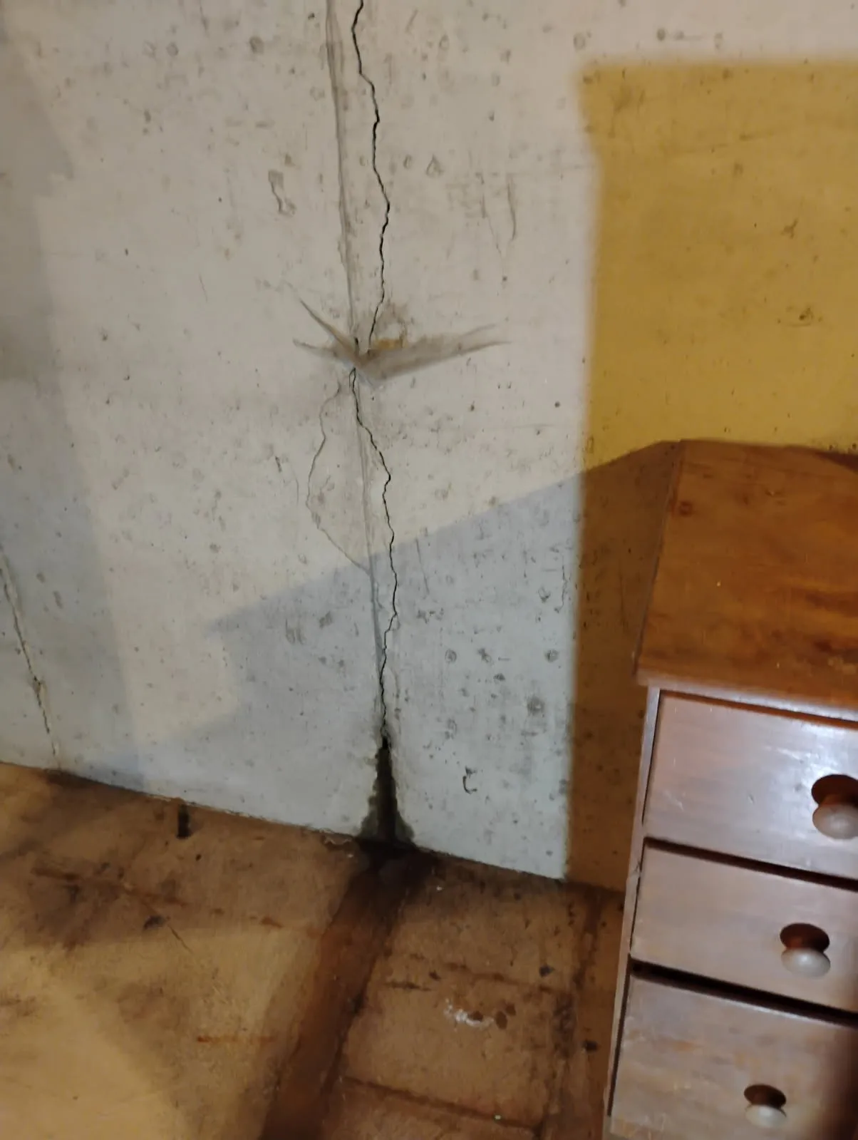Close-up of active water leak through foundation crack in Framingham basement
