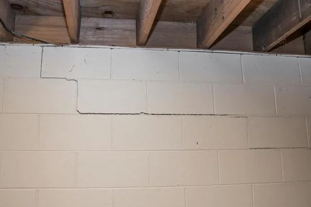 Horizontal foundation crack showing lateral soil pressure damage on basement wall