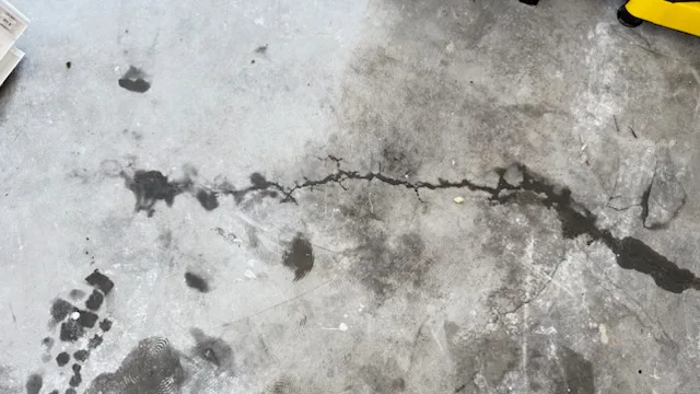 Basement floor crack with water seepage before repair